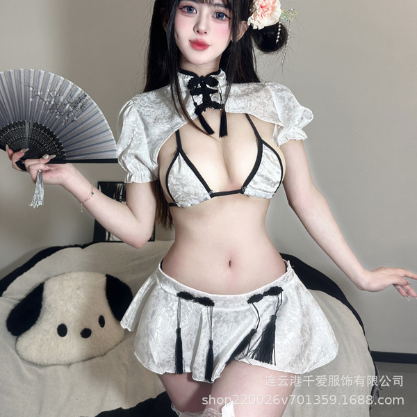 A woman models a classic chinese qipao lingerie set, featuring a delicate white design with black accents, perfect for seduct...