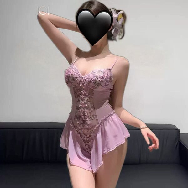 Woman wearing pink floral lace lingerie sleepwear set with sheer mesh and push-up bodysuit design.