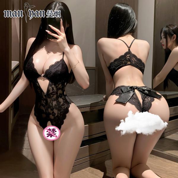 Woman modeling black lace temptation open-crotch bodysuit, sheer lingerie set with floral lace and bow back detail.