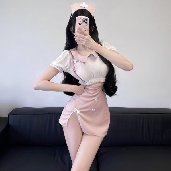 Woman modeling pink nurse-inspired lingerie set with sheer lace halter top and matching skirt, perfect for role play or date ...