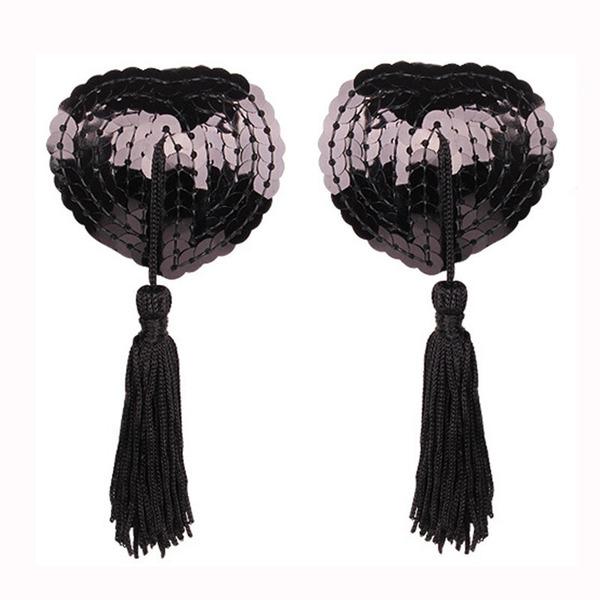 Heart-shaped silicone bra inserts with sequins and lace trim, featuring black tassels for a flirty look.