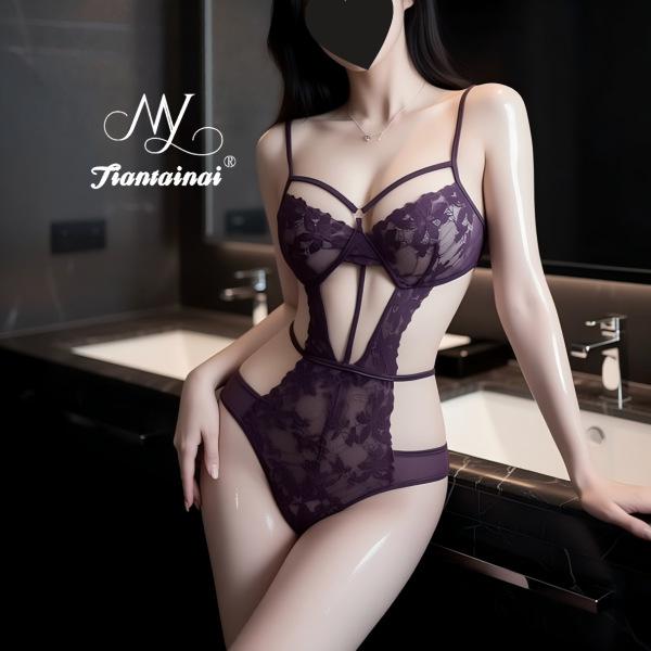 Woman modeling purple lace lingerie set in bathroom - sheer bra and high-waist panties with floral detailing.