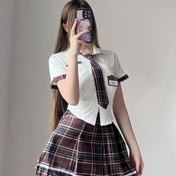 Woman wearing a plus size sexy jk uniform set with a white shirt, plaid tie, and skirt for schoolgirl role play.