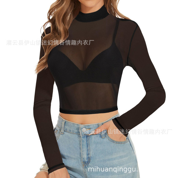 Woman wearing a black sheer mesh long sleeve crop top with high neck, styled as lingerie, paired with blue jeans.