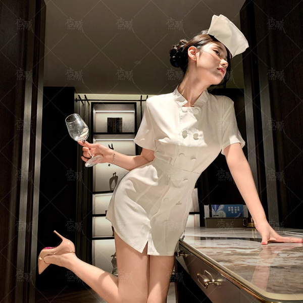 Woman in 2025 sexy nurse costume set posing with wine glass, white uniform and cap for cosplay & role play.