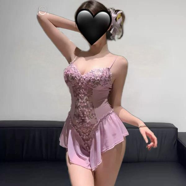 Woman wearing pink floral lingerie sleepwear set with lace trim, sheer mesh panels, and push-up bodysuit design.