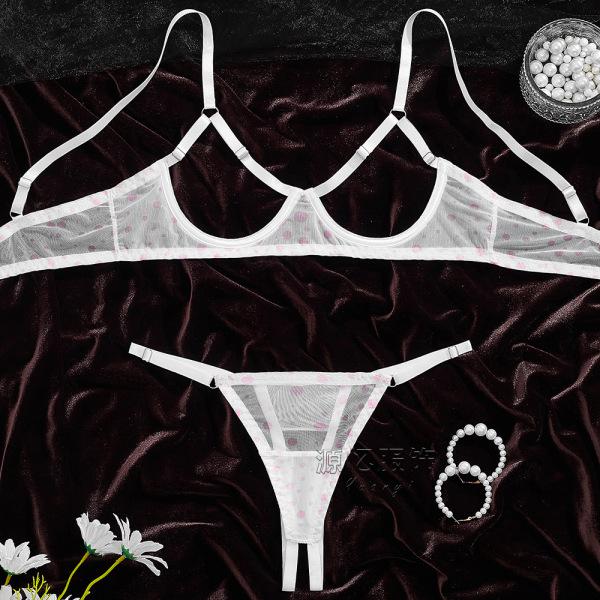 Sheer white bra and panty set with pink polka dots on dark velvet, styled with pearls and flowers.