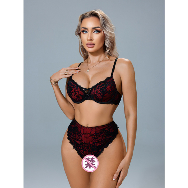 Woman modeling red lace lingerie set with black trim, featuring busty illusion design for small bust.