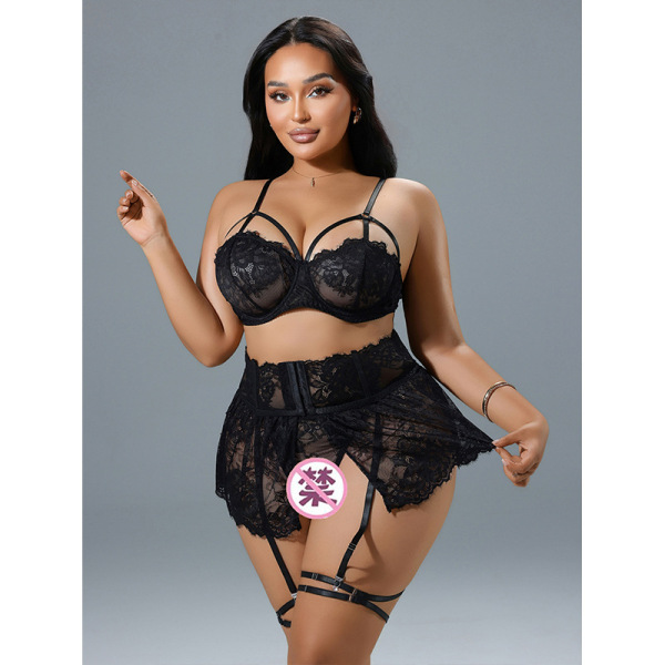 Woman modeling black sheer mesh lace lingerie set with thigh rings, featuring a bra, garter belt, and stockings.