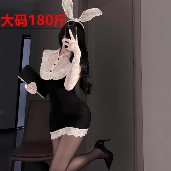 Woman in black bodycon dress with white lace collar, bunny ears, and gloves posing for mirror selfie.
