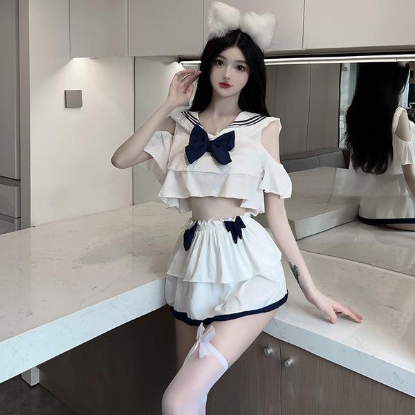 A stylish outfit featuring a sailor-themed top with ruffles and a large bow, paired with a pleated mini skirt and matching ac...