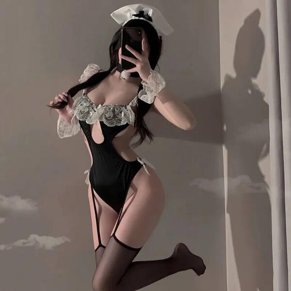 A woman poses in a black maid costume set featuring lace details, perfect for cosplay or themed events. includes sleepwear an...