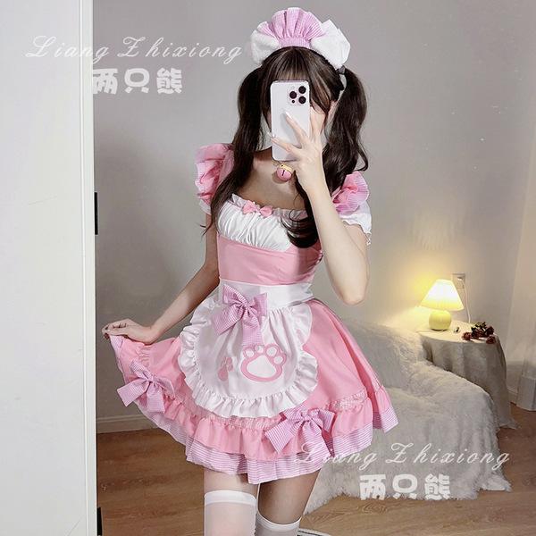 A woman wearing a pink maid dress with ruffles and bows, perfect for cosplay or anime-themed events.