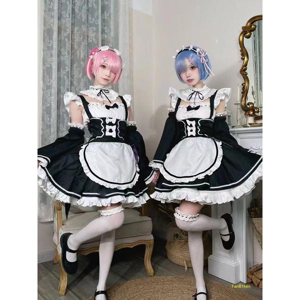 Two cosplayers dressed as ram and rem from re:zero, wearing maid outfits in lolita style. black and white dresses with ruffle...