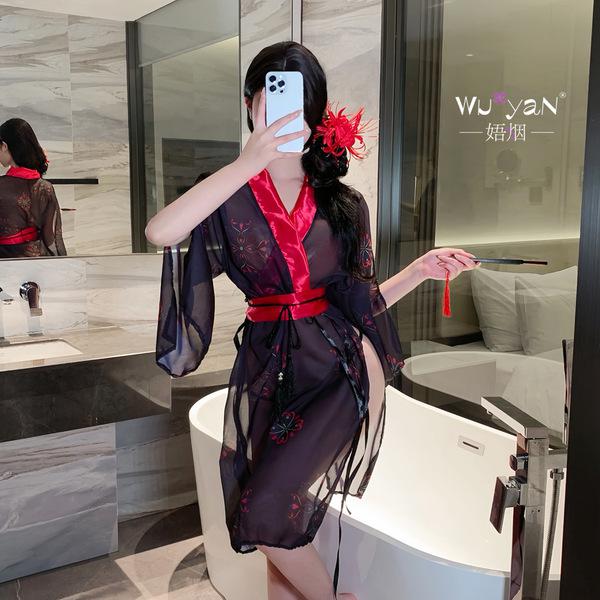 A woman poses in a bathroom wearing a sheer hanfu-inspired erotic robe, featuring red accents and floral patterns, capturing ...