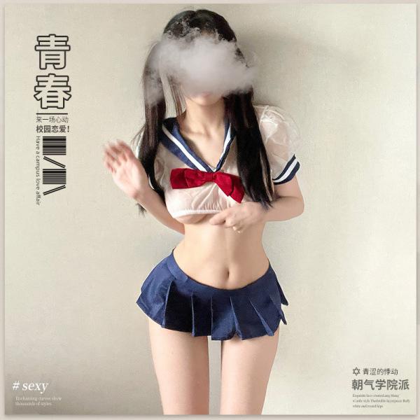 Woman modeling qingruohan sexy jk uniform set with pleated mini skirt and sailor top for adult role play.