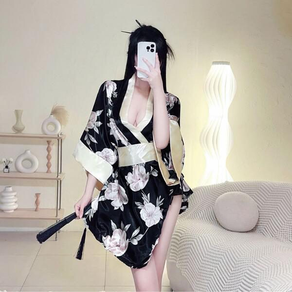 A woman poses in a japanese kimono lingerie set featuring a floral print and dramatic sleeves, holding an umbrella against a ...