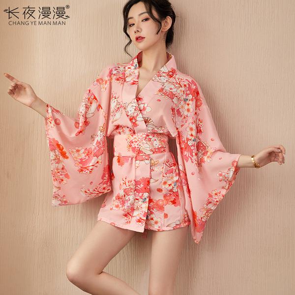 A woman models a pink floral patterned kimono-style dress with sheer sleeves, featuring a corset design, suitable for women s...