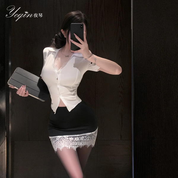 Woman in white deep v-neck blouse with lace trim and black bodycon skirt, holding clutch and phone, wearing night seductive ...