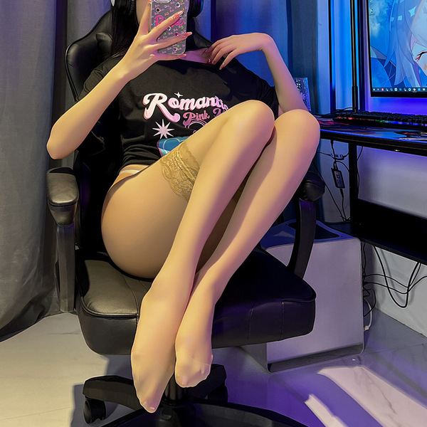 Woman wearing lace trim thigh-high stockings, sitting on a chair with legs crossed, showcasing the stockings design and fit.