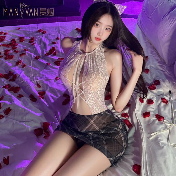 Woman in manyan ol secret cosplay uniform: sheer plaid bodysuit with backless design & bodycon skirt, on bed with rose petals...