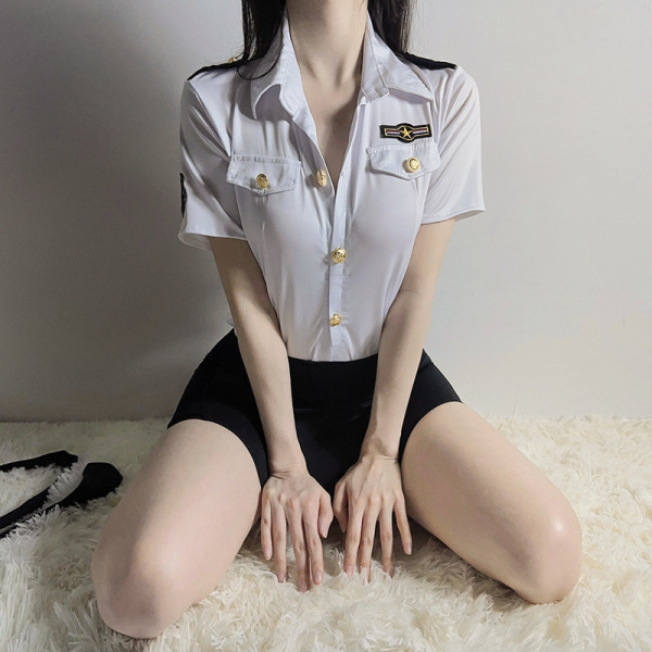 Woman wearing airu airu sexy flight attendant costume with short skirt and white shirt, sitting on a fluffy rug.