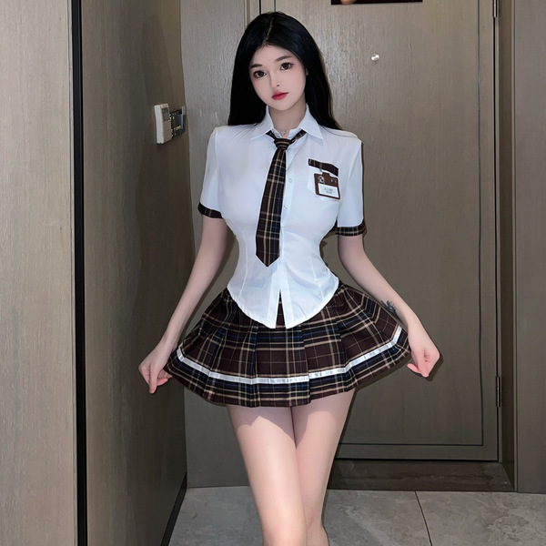 A stylish jk schoolgirl outfit featuring a white blouse with a plaid tie and matching skirt, perfect for women seeking a chic...