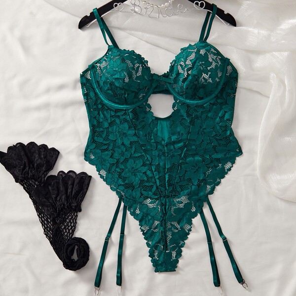 Emerald green lace bodysuit with open-crotch design and matching black stockings, perfect for romantic nights.