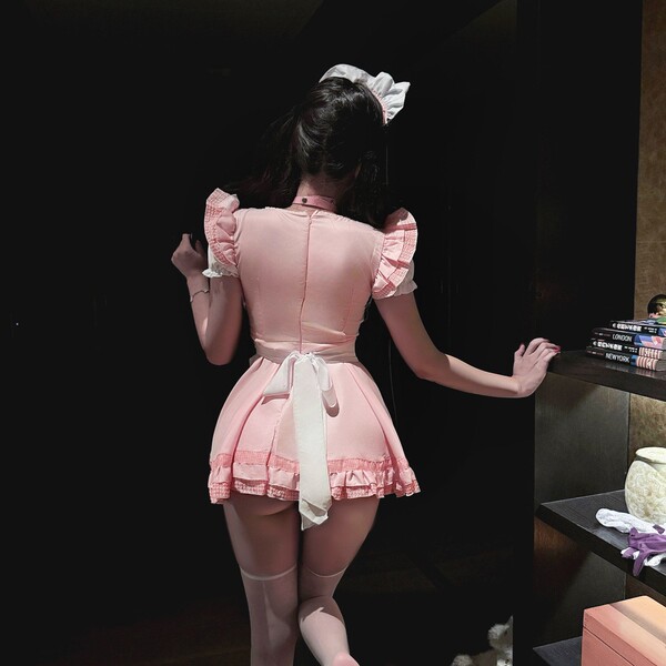 A woman models the baodan maid costume cosplay dress, featuring a cute cat girl design with ruffled sleeves and skirt, perfec...