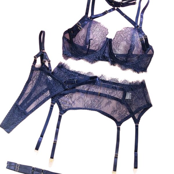 Navy lace lingerie set with beanie-trimmed jk-style bra, garter belt, and stockings for playful elegance.