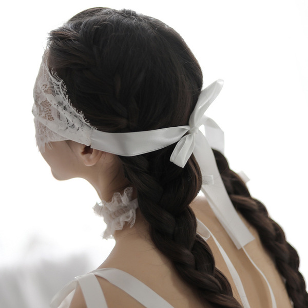 Elegant white lace eye mask with black accents, perfect for adults seeking a sensual sleep accessory or roleplay accessory.
