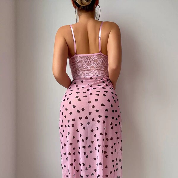 Pink lace dress with black heart pattern, featuring a delicate design and spaghetti straps, perfect for feminine elegance.
