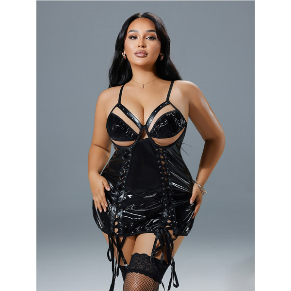 Model wearing black patent leather lace-up lingerie set with cutout bra and panty, stylish and bold design.