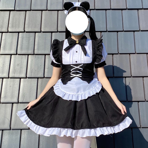 A woman models a black and white gothic lolita maid dress with puffy sleeves, ruffled skirt, and mouse ears headband, perfect...