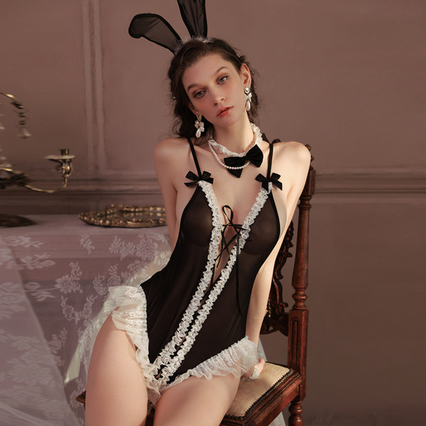 Woman wearing black bunny girl lingerie bodysuit with white lace, bow ties, and bunny ears—sexy open-crotch costume for adult...