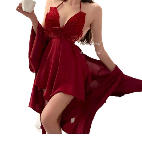 Woman wearing red butterfly lace sleep dress with bow detail and sheer back, holding a cup, romantic spring lingerie set.