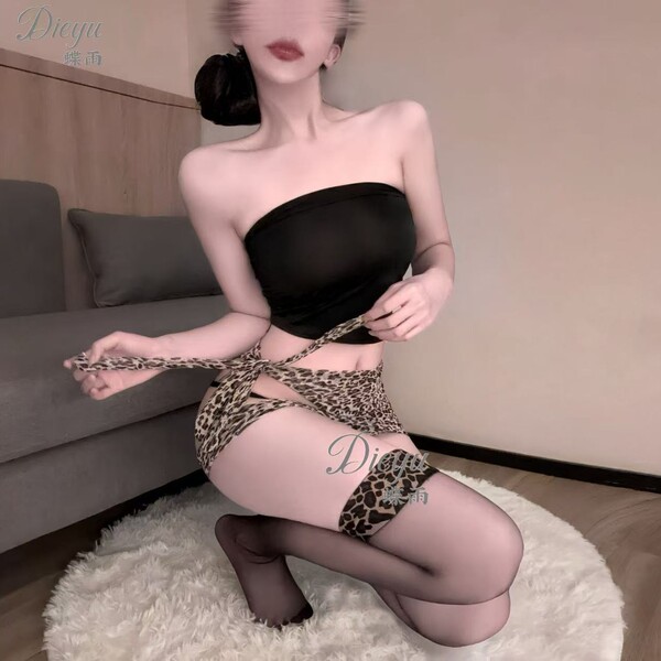 Woman kneeling in black strapless top and leopard print cut-out bodysuit with matching garter belt, sheer stockings.