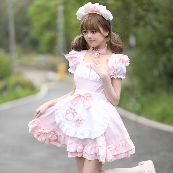 A stylish individual wears a charming pink maid costume, complete with a fluffy apron featuring paw prints, perfect for cospl...