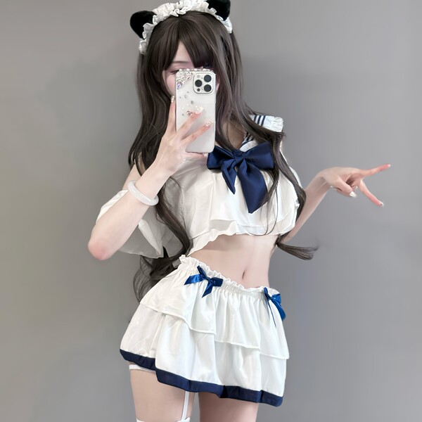 A stylish schoolgirl uniform set featuring a white top with navy blue accents, ruffled skirt, and playful bow details, perfec...