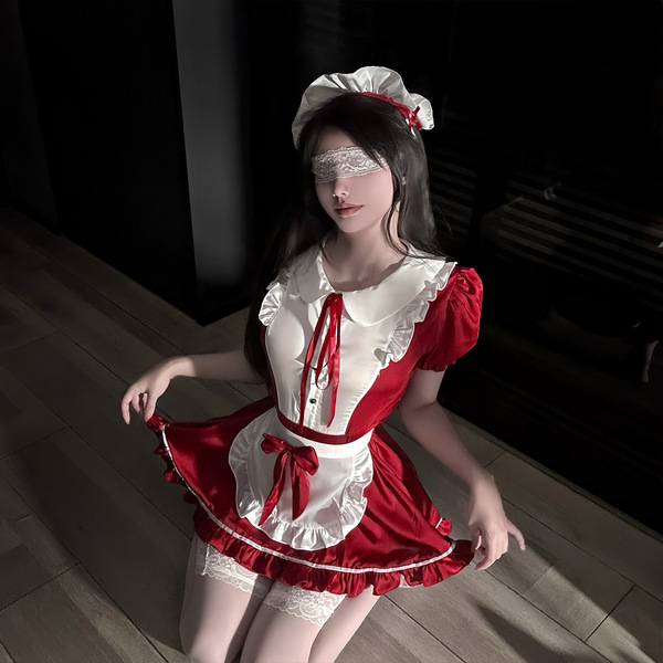 A woman poses in a maid-themed outfit featuring a red and white dress with lace details, perfect for cosplay or adult enterta...
