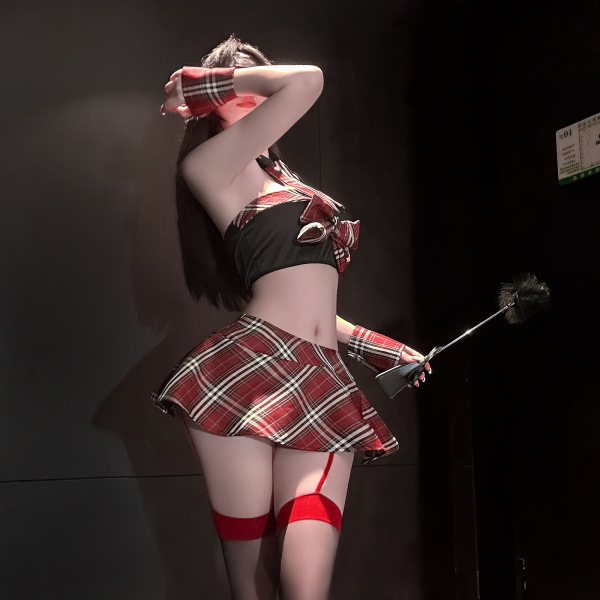 Woman in red plaid chao mu sensual lingerie set with jk skirt, holding a feather duster.