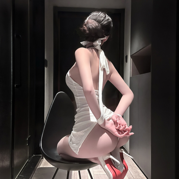 Woman in chao mu sexy secretary costume set with bodycon mini skirt, posing seductively on a chair.