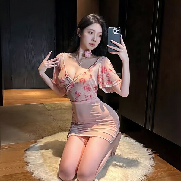 Woman wearing chaomu rose temptation lingerie set, sheer floral bustier skirt with sensual confidence pose.