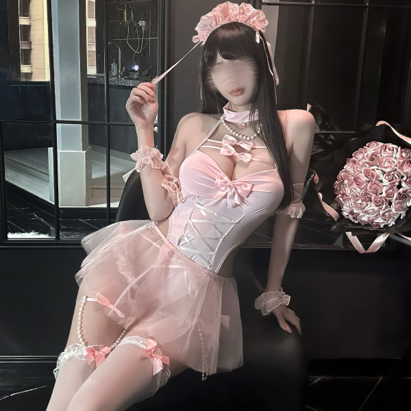 Woman in pink chaomu sensual lingerie set with lace, pearls, and floral headpiece, posing elegantly indoors.