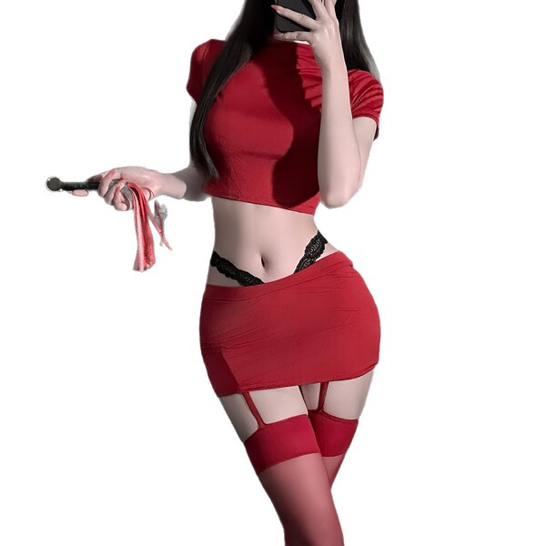 Woman in red secretary-style lingerie set with crop top, mini skirt, and thigh-high stockings holding a whip.