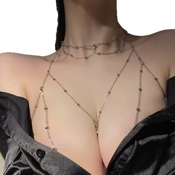 Woman wearing a sparkling crystal body chain with cherry blossom details, styled as a sexy lingerie accessory.