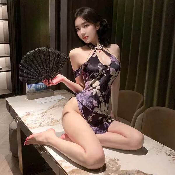A woman poses elegantly in a purple cherry blossom vintage qipao lingerie set, featuring a halter neck design and floral patt...