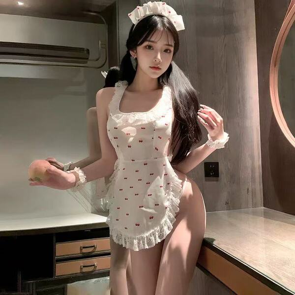 Woman wearing a cherry lace maid costume with a backless apron, cheeky cut-outs, and sheer trim.