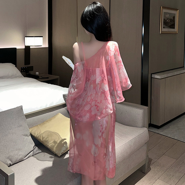 A woman stands facing away from the camera, wearing an elegant pink cherry blossom design original chinese-inspired lingerie ...