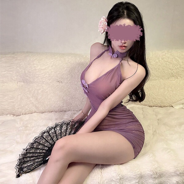 Woman in purple sheer qipao lingerie with floral embroidery, bodycon fit, lace fan accessory, and flower hairpiece on plush w...